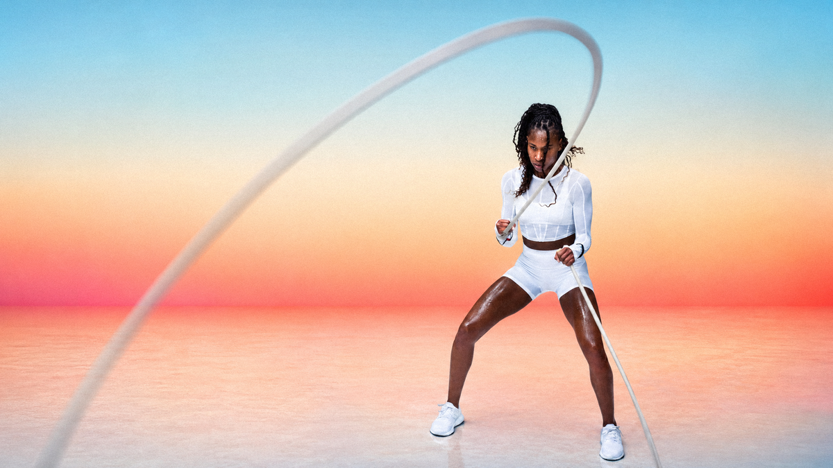 Athlete training with battle rope at sunset